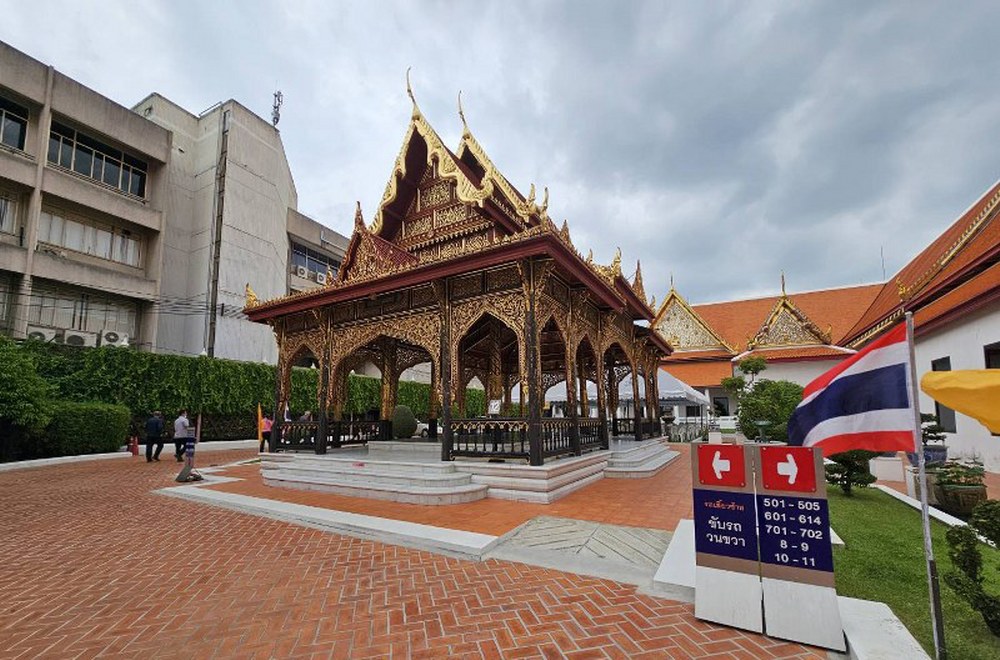 Elegant traditional Thai pavilion with intricate golden wood carvings inside the museum grounds.
