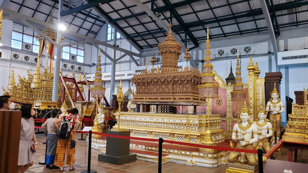 Royal cremation chariot with intricate golden craftsmanship.