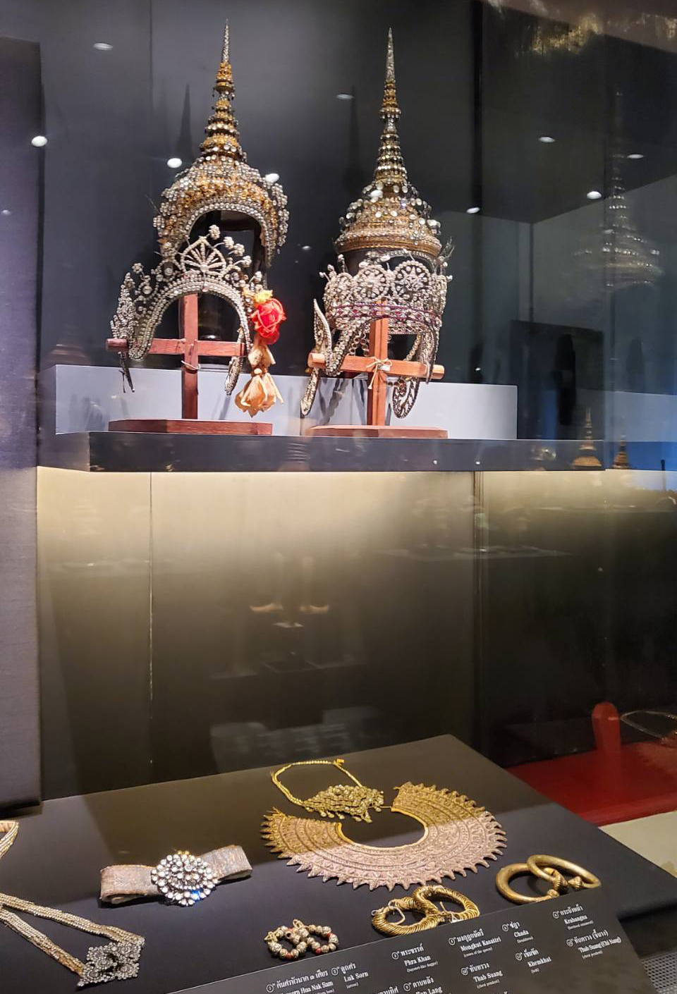 Traditional Thai royal headdresses and jewelry on display.
